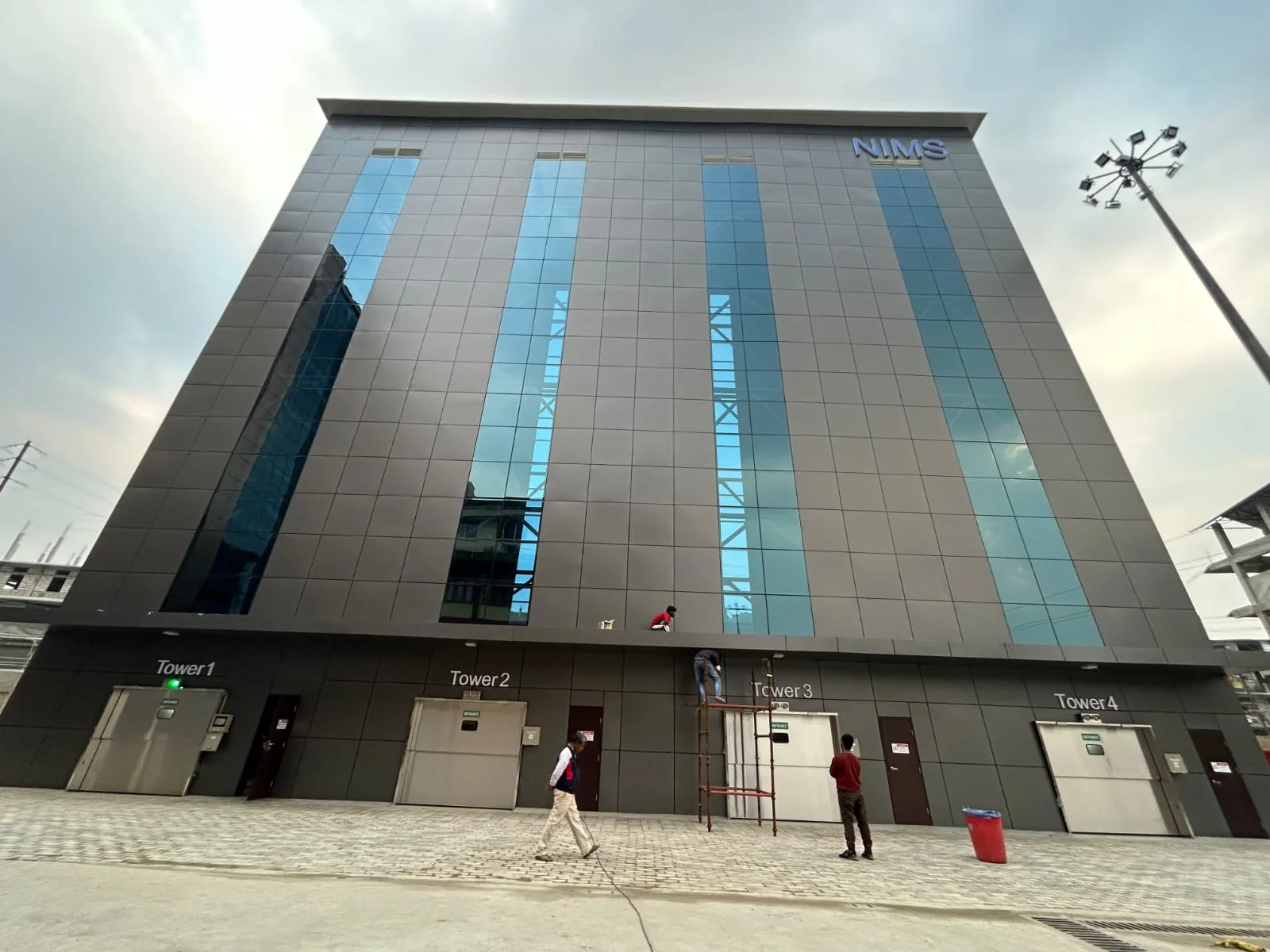 Finished commercial façade with vertical glazing strips.