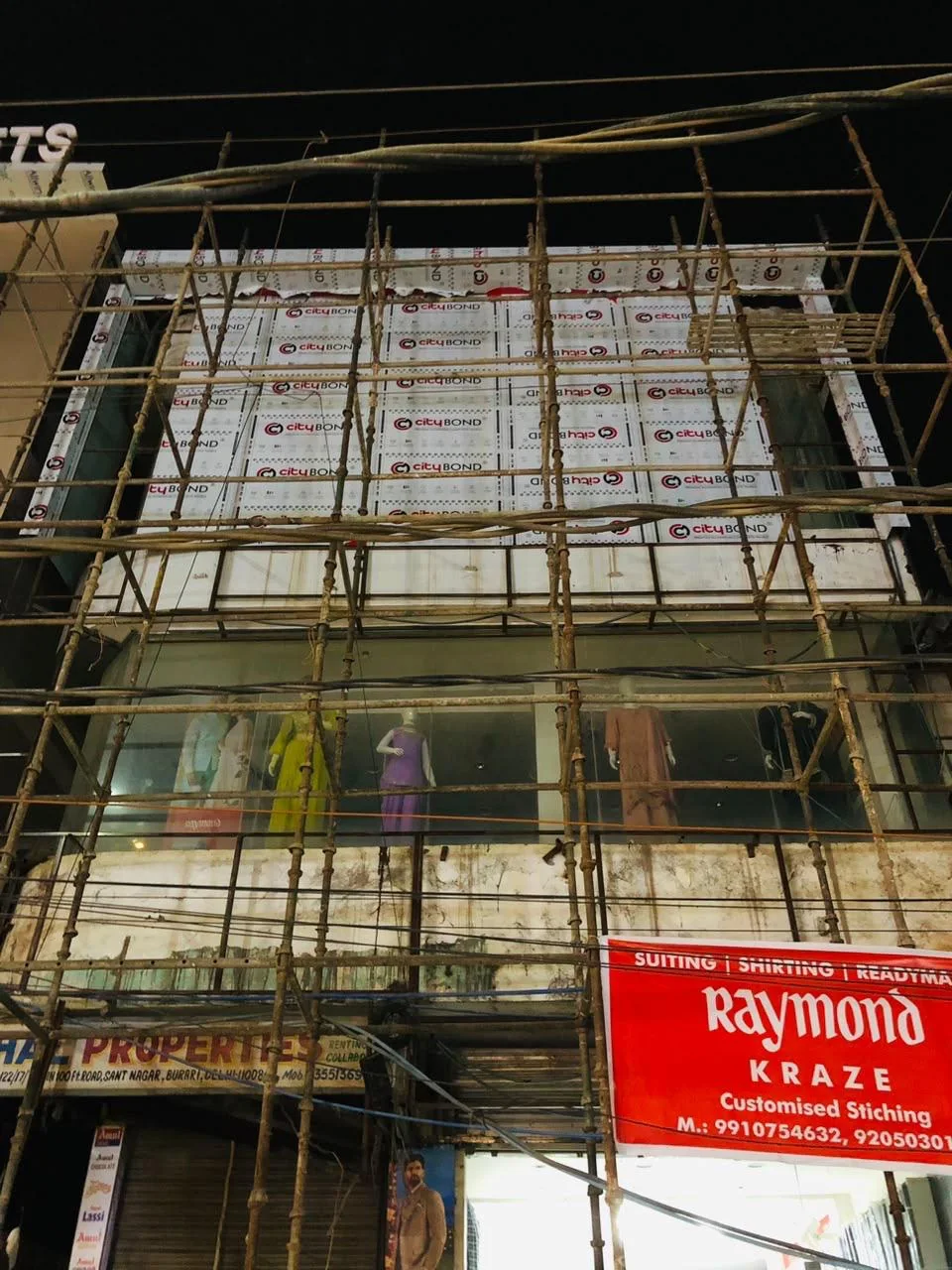 Commercial frontage with scaffolding during installation.