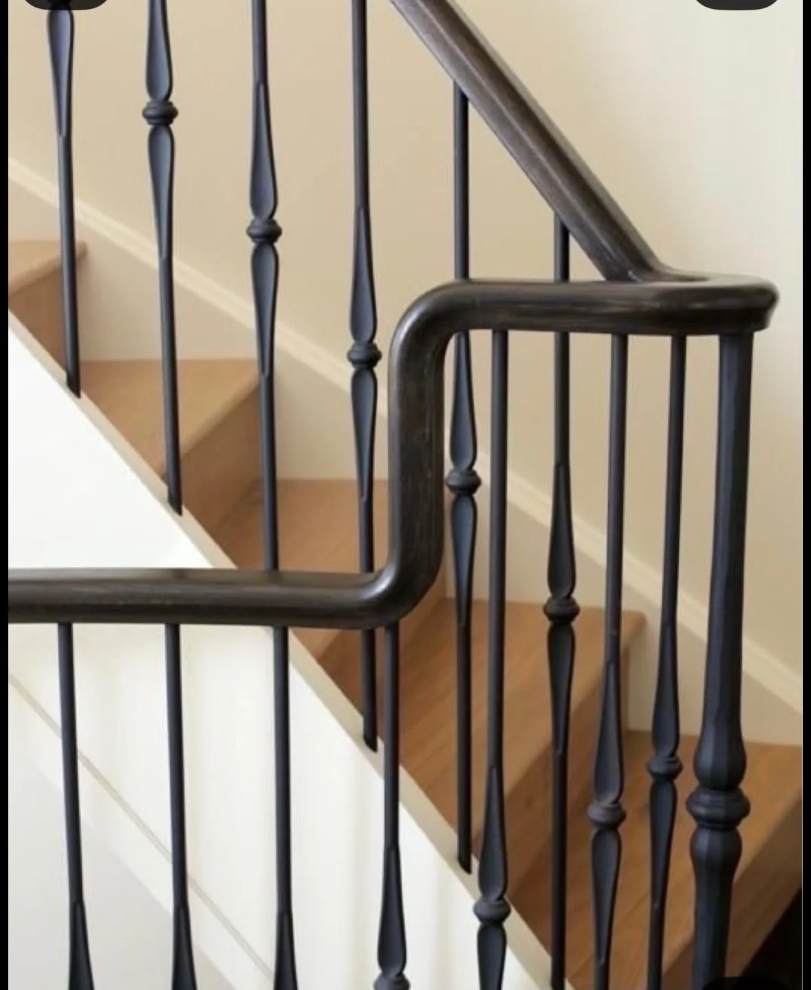 Close view of wrought stair railing.