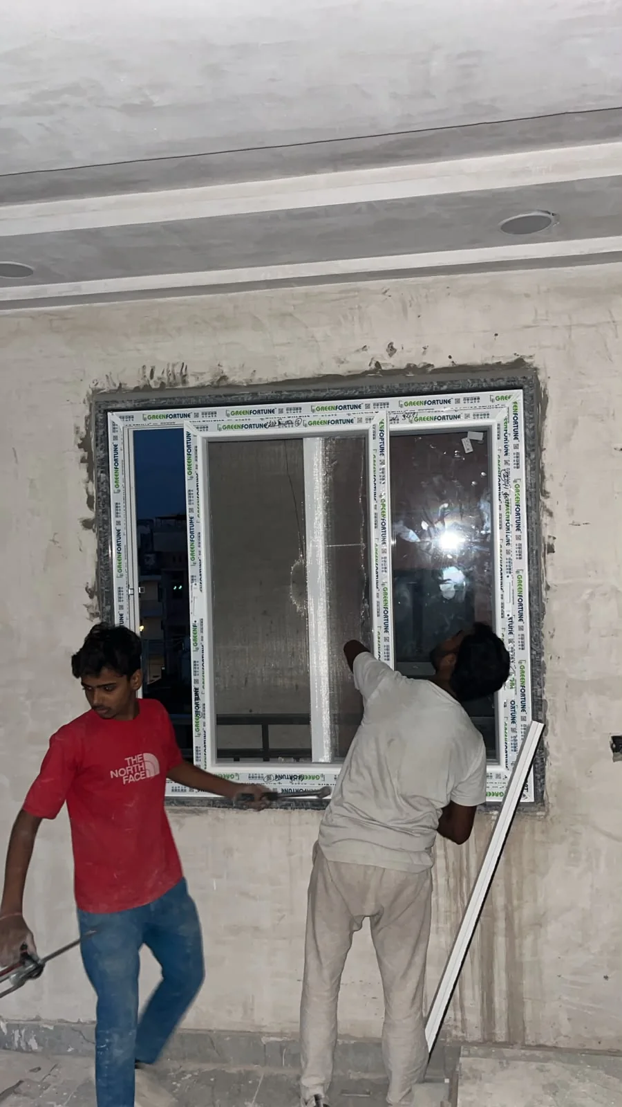 Team installing window on site.