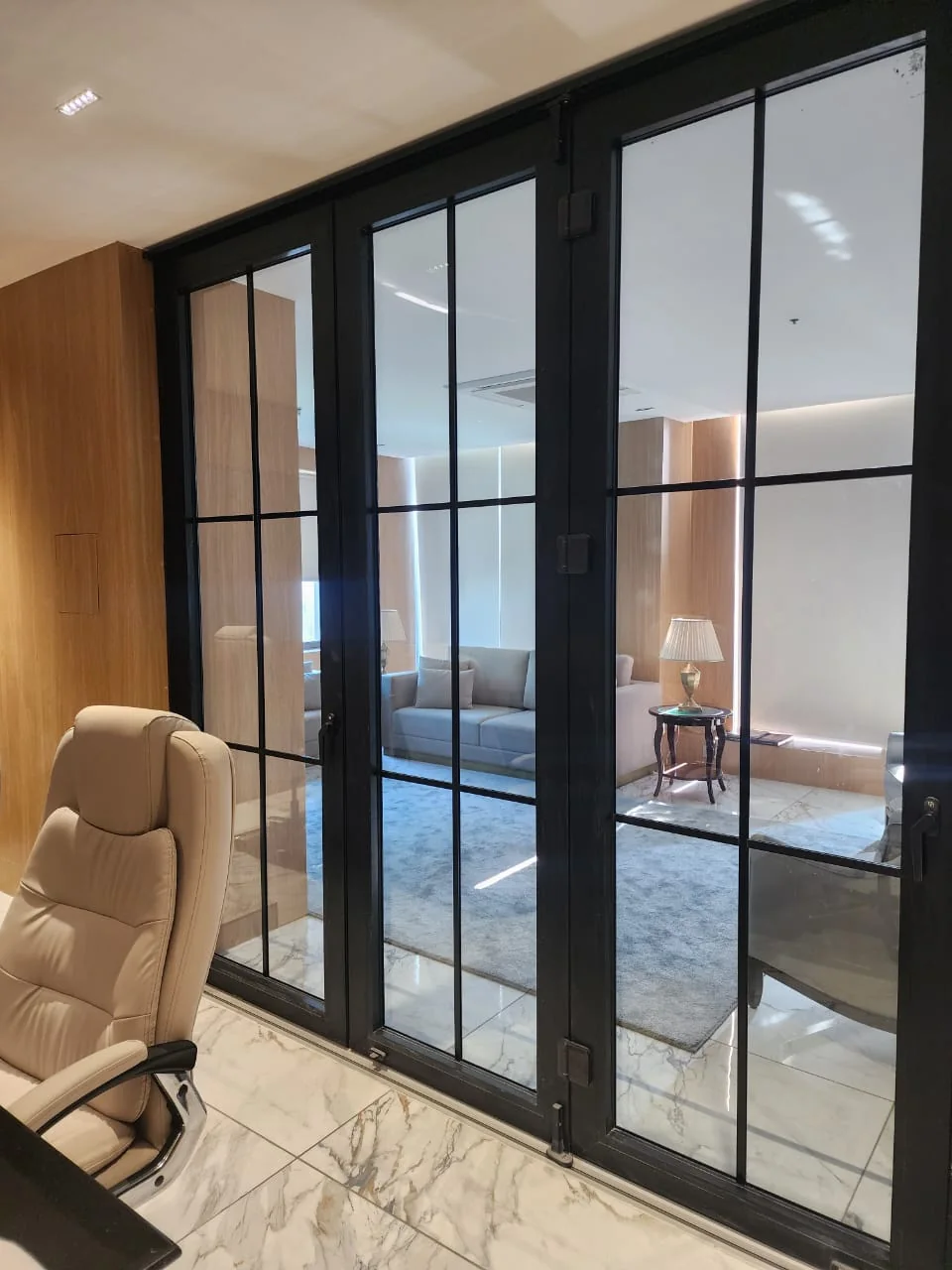 Black-framed glazed doors in finished interior.